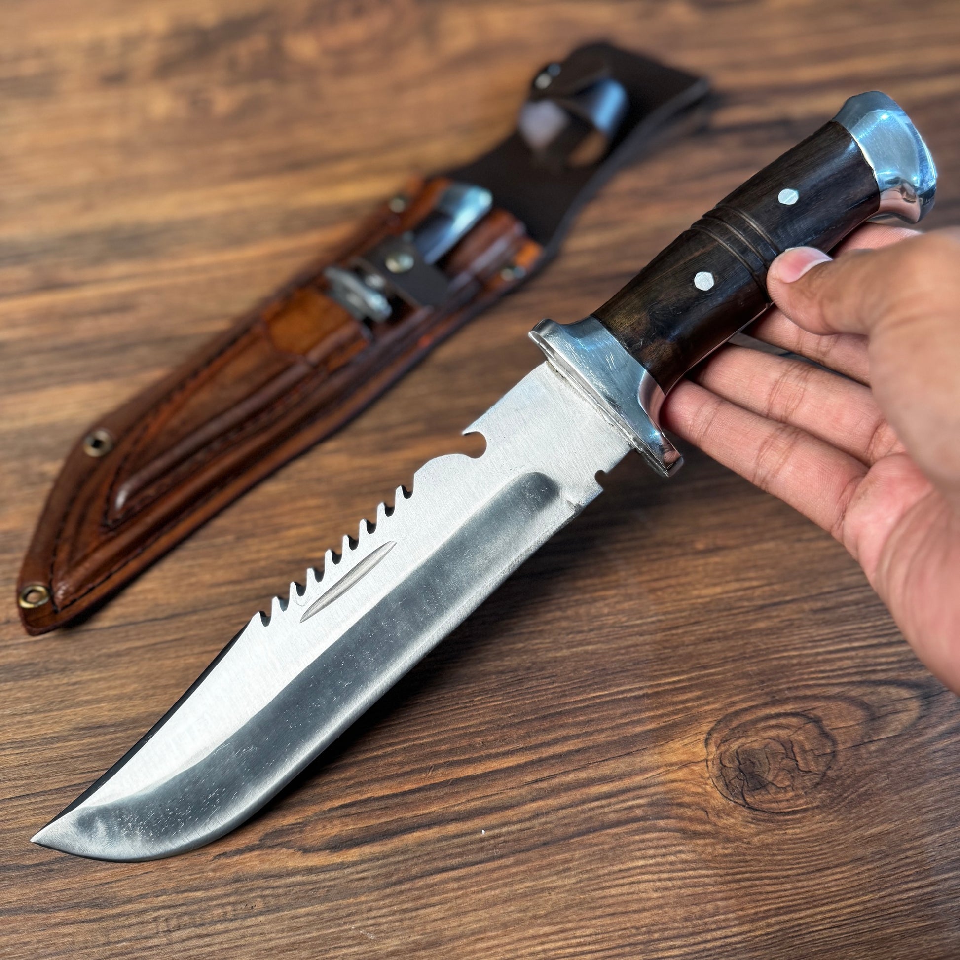 rosewood handle hand forged bowie knife leather sheath traditional carved detail view