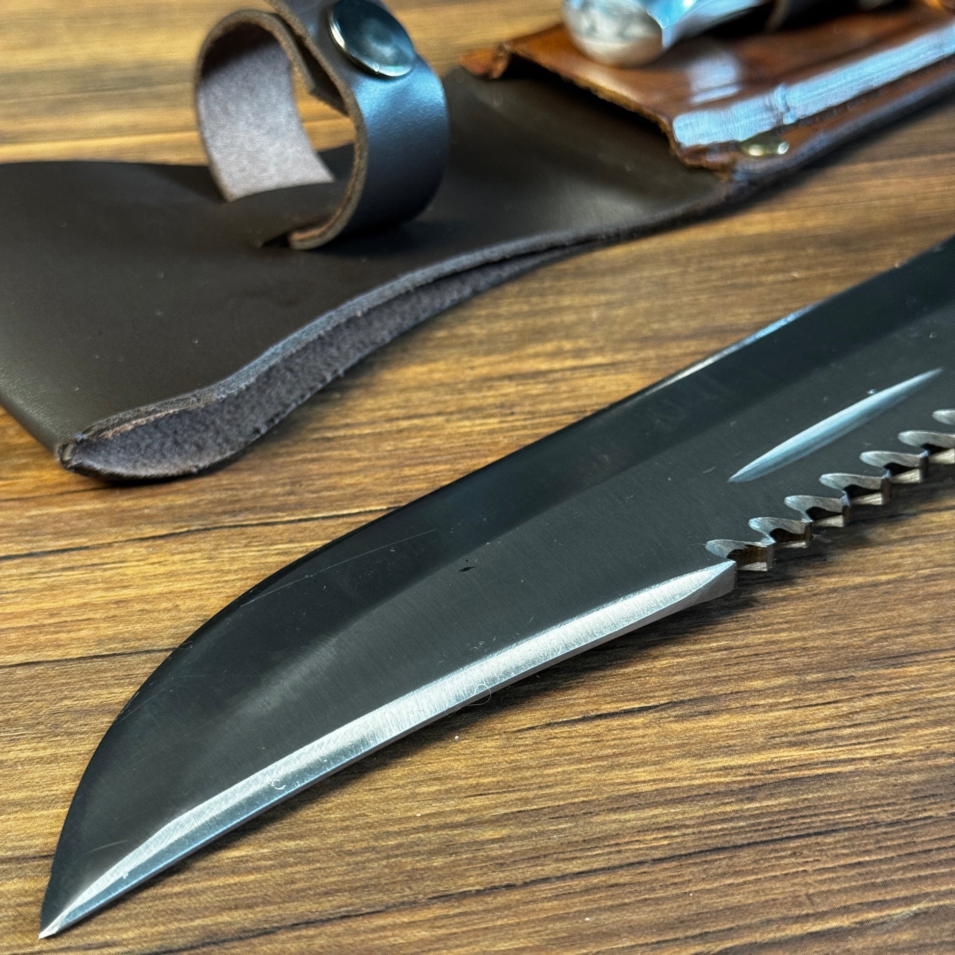 hand forged bowie knife leather sheath brown leather hand stitched close up