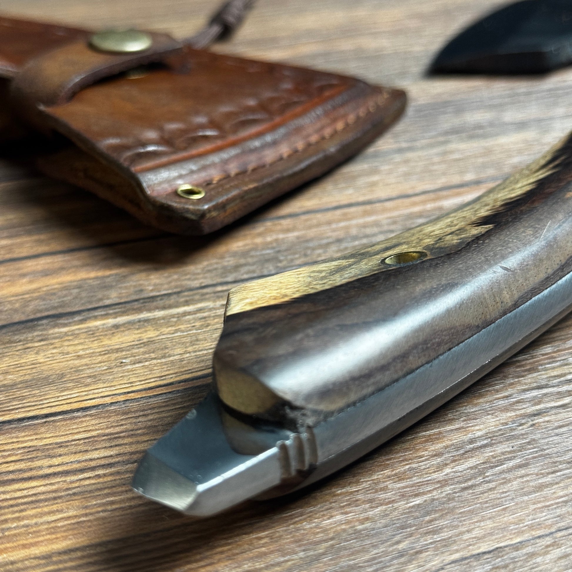 batik leather sheath hand forged full tang axe hand stitched pattern close up