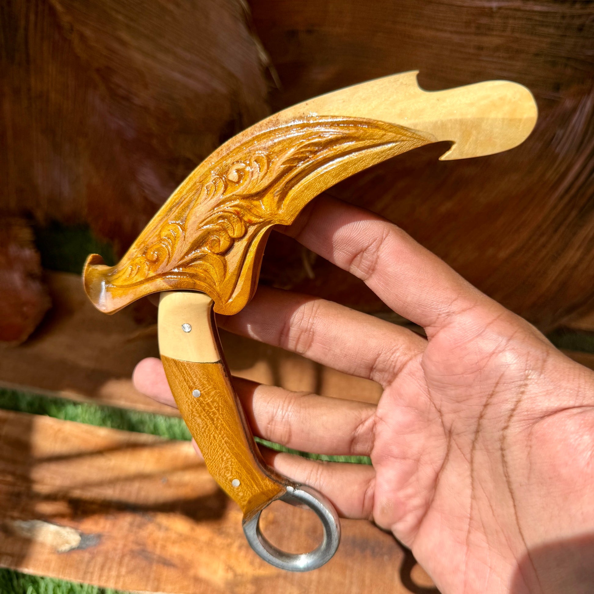 teak handle hand-forged karambit spring steel traditional hand carved detail view