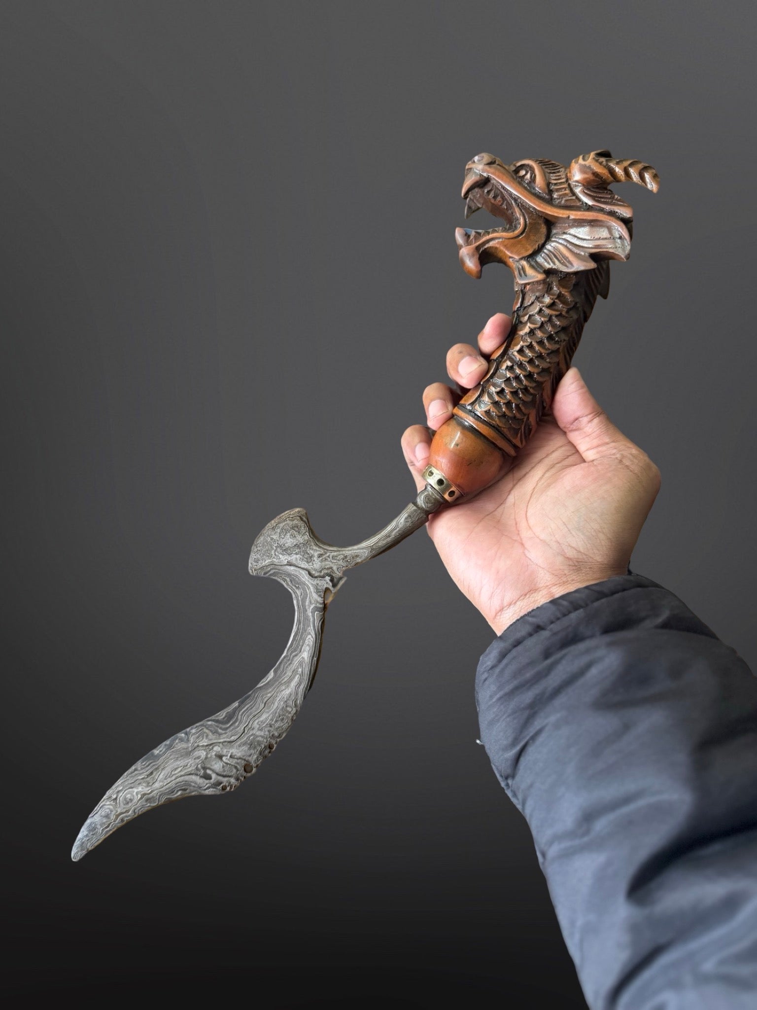 carved teak handle hand-forged Indonesian Kujang dragon pattern traditional detail
